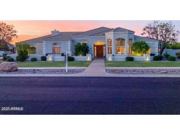 Stunning single-story home featuring an inviting front yard and a well-manicured lawn, complemented by a beautiful sunset backdrop at 2251 N 32Nd St # 21, Mesa, AZ 85213