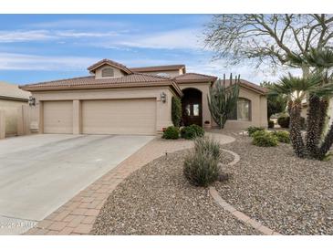 Charming single-story home with a three-car garage, desert landscaping, and a paved walkway leading to the entrance at 23731 S Angora Dr, Sun Lakes, AZ 85248