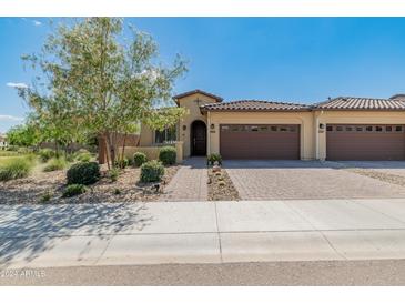 Charming single-story home featuring a tile roof, desert landscaping, and a two-car garage at 24670 N 171St Ln, Surprise, AZ 85387