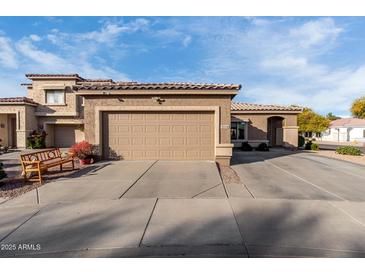 Charming home showcasing a large front entry garage and well maintained landscaping with a seating area at 2528 E La Costa Dr, Chandler, AZ 85249