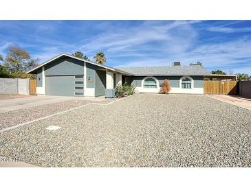 Charming single-story home with desert landscaping, covered parking, and a two-car garage at 2902 E Escondido Ave, Mesa, AZ 85204