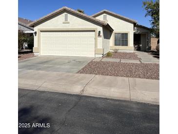 Charming single-story home featuring a two-car garage, desert landscaping, and a welcoming front entrance at 30169 N Sunray Dr, San Tan Valley, AZ 85143