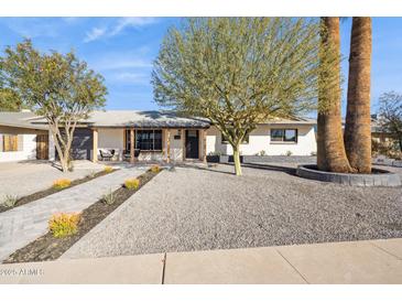 Charming single-story home featuring manicured landscaping, stone accents and a welcoming entrance at 3803 S Elm St, Tempe, AZ 85282