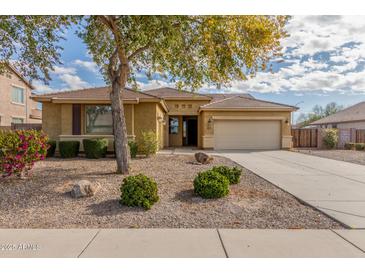 Charming single-story home featuring a well-maintained front yard and a two-car garage at 4033 S Harlan --, Mesa, AZ 85212