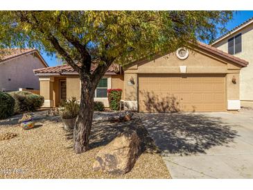 Charming single-story home with a well-manicured yard and a two-car garage at 4040 E Rowel Rd, Phoenix, AZ 85050