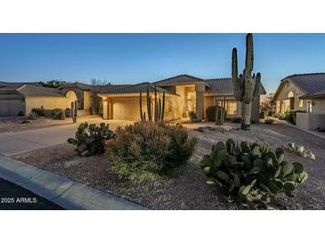 Beautiful Southwestern home with desert landscaping including cacti and neutral color palette at 5742 S Creosote Dr, Gold Canyon, AZ 85118