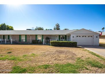 Charming single-story home showcasing its well-maintained yard and attached garage at 10105 W Bolivar Dr, Sun City, AZ 85351