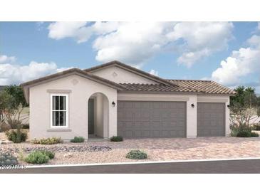 Charming single-story home with a stucco exterior, tile roof, and a two-car garage at 18252 W Hess St, Goodyear, AZ 85338