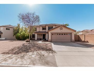 Home with a two-car garage, desert landscaping, and views of the roof and surrounding homes at 1114 S Grenoble --, Mesa, AZ 85208