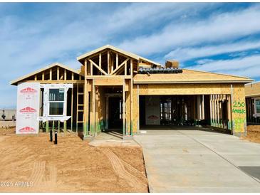 New construction home featuring wood framing, a concrete driveway, and Thermo-Sheath structural sheathing at 11980 E Aster Ln, Florence, AZ 85132