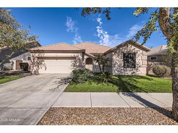 Charming single-story home with a well-maintained lawn and two-car garage in a desirable neighborhood at 13594 W Port Royale Ln, Surprise, AZ 85379