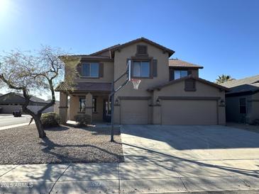 Charming two-story home with three-car garage and a well-maintained desert landscaped front yard at 1637 W Green Tree Dr, San Tan Valley, AZ 85144