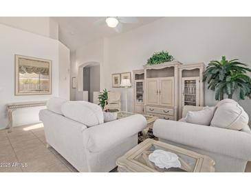 Spacious living room featuring neutral tones, vaulted ceilings, and stylish furnishings at 17697 W Sunbelt Dr, Surprise, AZ 85374