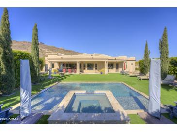 Beautiful backyard features a pool, spa, lush landscaping, and a covered patio perfect for outdoor living at 2729 W Dolores Rd, Phoenix, AZ 85086