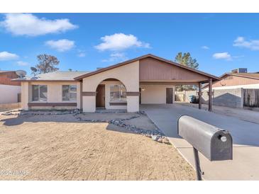 Charming single-story home with a covered carport and low-maintenance desert landscaping at 2815 W Charleston Ave, Phoenix, AZ 85053