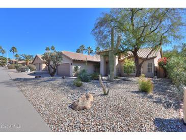 Charming single-story home features desert landscaping, mature trees, and a tile roof on a sunny day at 309 E Mountain Sky Ave, Phoenix, AZ 85048