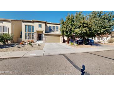 Charming two-story home with landscaped yard, covered entrance, and attached two-car garage at 33732 N Sandstone Dr, San Tan Valley, AZ 85143