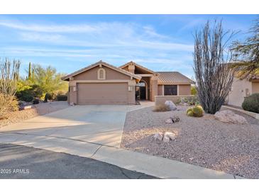 Charming single-story home featuring desert landscaping and an attached two-car garage at 8499 E Jumping Cholla Dr, Gold Canyon, AZ 85118