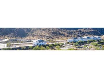 View of modern houses in a new construction community nestled in a beautiful mountain range at 9814 S 11Th St, Phoenix, AZ 85042