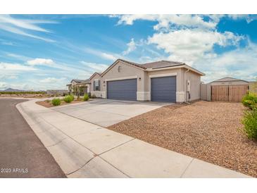 Charming single-story home showcasing a spacious three-car garage and low-maintenance desert landscaping at 1021 W Descanso Canyon Dr, Casa Grande, AZ 85122