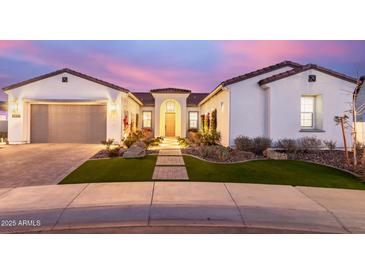 Inviting exterior of home featuring manicured front yard with stone walkway and charming facade at 11143 N Mckinney St, Surprise, AZ 85388