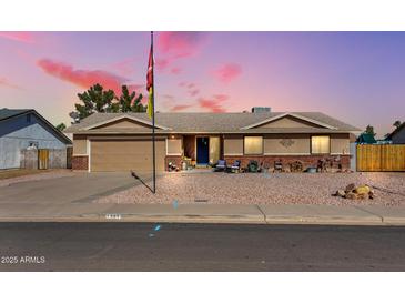 Charming single-story home with desert landscaping and inviting front porch seating at 1353 N Avoca --, Mesa, AZ 85207