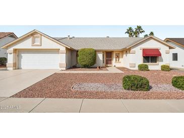 Charming single-story home featuring a two-car garage and low-maintenance desert landscaping at 13548 W Whitewood Dr, Sun City West, AZ 85375