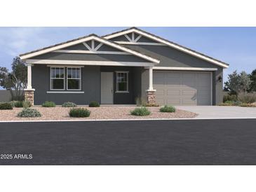 Charming single-story home with a two-car garage and well-manicured landscaping at 15762 W Cheryl Dr, Waddell, AZ 85355