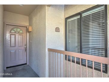 Inviting condo entrance featuring stylish front door, balcony, and unit number at 16631 E El Lago Blvd # 214, Fountain Hills, AZ 85268