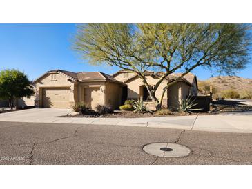 Charming single-story home with a three-car garage and mature landscaping at 1728 W Eagle Talon Trl, Phoenix, AZ 85085