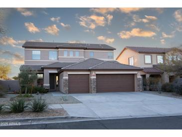 Spacious two-story home with a three-car garage and well-manicured front yard at 17441 W Rock Ledge Rd, Goodyear, AZ 85338