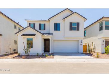 Charming two-story white home with a two-car garage and well-maintained front yard at 2195 N Peden Dr, Chandler, AZ 85225