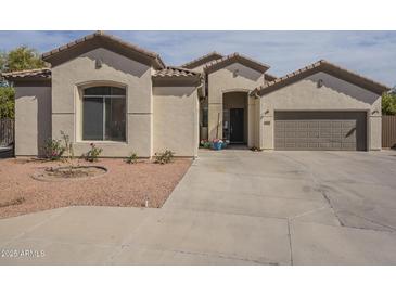 Charming single-story home with desert landscaping, covered entrance, and attached garage at 4541 N 129Th Dr, Litchfield Park, AZ 85340