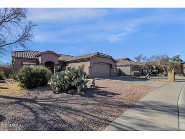 Charming single-story home with a well-manicured desert landscape and a private two-car garage at 4658 S Rufino Ln, Gold Canyon, AZ 85118