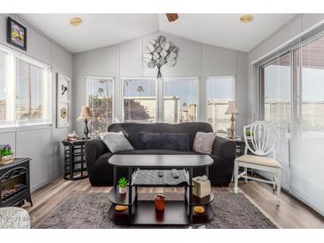 Comfortable living room with neutral walls, stylish furnishings, and plenty of natural light at 111 S Greenfield Rd # 97, Mesa, AZ 85206