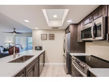 Modern kitchen featuring sleek countertops, stainless steel appliances, and ample natural light at 18624 N 92Nd Dr, Peoria, AZ 85382