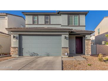 Two-story home with a gray exterior, gray garage door and a stacked stone accent on the columns at 2622 E Monument Canyon Ave, Apache Junction, AZ 85119