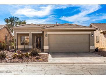 Charming single-story home features a desert landscape, a two-car garage, and a tile roof at 30124 N Sunray Dr, San Tan Valley, AZ 85143