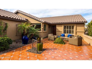 Inviting patio with tiled flooring, comfortable seating, and decorative planters, perfect for outdoor relaxation at 3648 N 162Nd Ave, Goodyear, AZ 85395