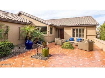 Inviting outdoor patio with comfortable seating and decorative potted plants at 3648 N 162Nd Ave, Goodyear, AZ 85395