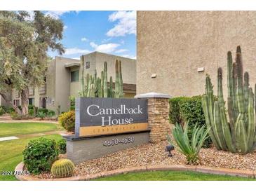 Exterior of complex showing community signage with desert landscaping and multi-level building at 4620 N 68Th St # 116, Scottsdale, AZ 85251