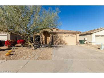 Charming single-Gathering home with a two-car garage, desert landscaping, and mature tree at 6042 W Warner St, Phoenix, AZ 85043