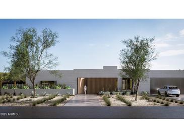 Modern exterior elevation with desert landscaping, light brick, wood accents, and a sleek, contemporary design at 6232 E Bret Hills Dr, Paradise Valley, AZ 85253