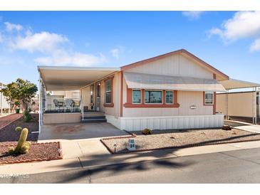 Charming single-story home featuring a covered porch and a well-maintained yard with desert landscaping at 7807 E Main St # Cc-84, Mesa, AZ 85207