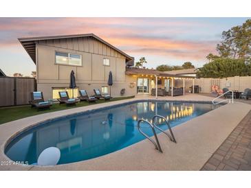 Relaxing backyard pool with lounge chairs and covered patio, perfect for outdoor entertaining at 8307 E Montebello Ave, Scottsdale, AZ 85250