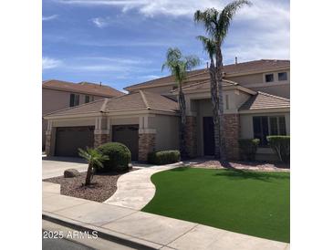 Charming home exterior featuring a well-manicured lawn, stone accents, and mature palm trees at 9765 E Lompoc Ave, Mesa, AZ 85209