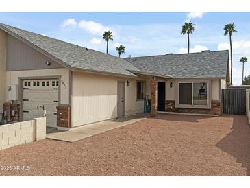 Charming single-story home with a well-maintained yard and attached garage at 9853 E Birchwood Ave, Mesa, AZ 85208