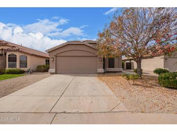 Charming single-story home with a well-maintained front yard, a two-car garage and desert landscaping at 1148 S Sierra St, Gilbert, AZ 85296