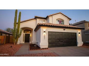 Charming two-story home with a well-kept front yard and a two-car garage at 13451 S 47Th Way, Phoenix, AZ 85044