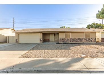 Charming single-story home featuring a two-car garage and low-maintenance landscaping at 1549 W Peralta Ave, Mesa, AZ 85202